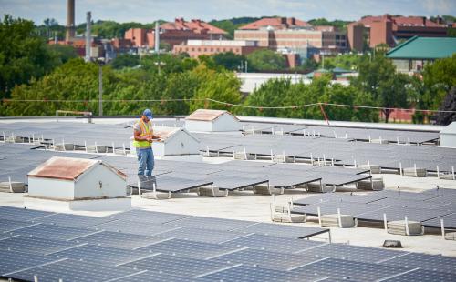 Solar installer on commercial roof in Minnesota, MnSEIA and RTO Insider