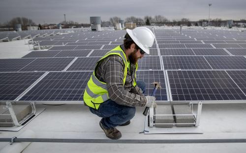 Minnesota solar workers install residential solar energy array MnSEIA